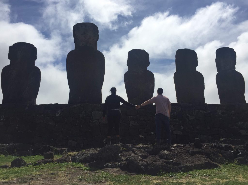 Holding hands behind Tongariki Easter Island