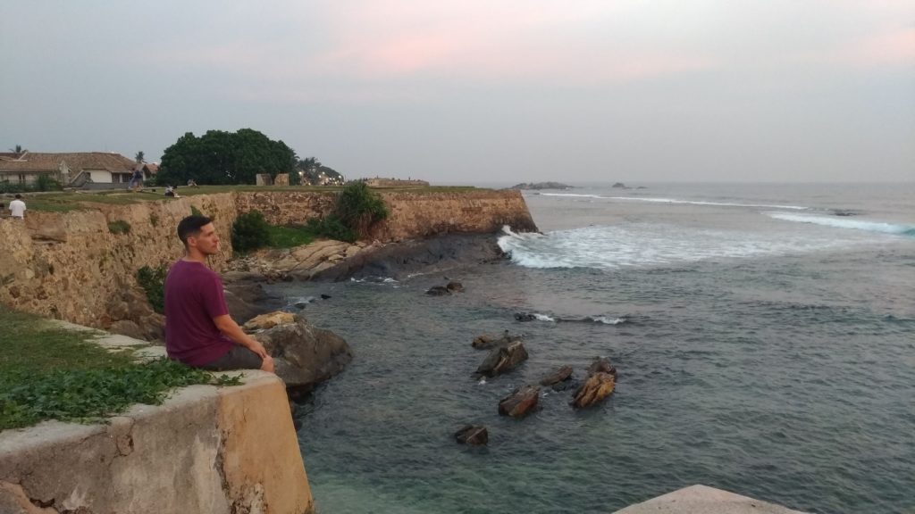 Sitting on ramparts Galle Fort Sri Lanka