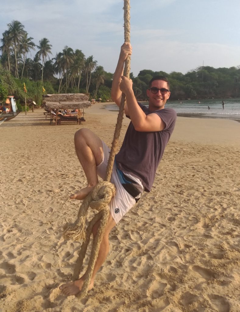 Rope swinging on Dickwella beach Sri Lanka