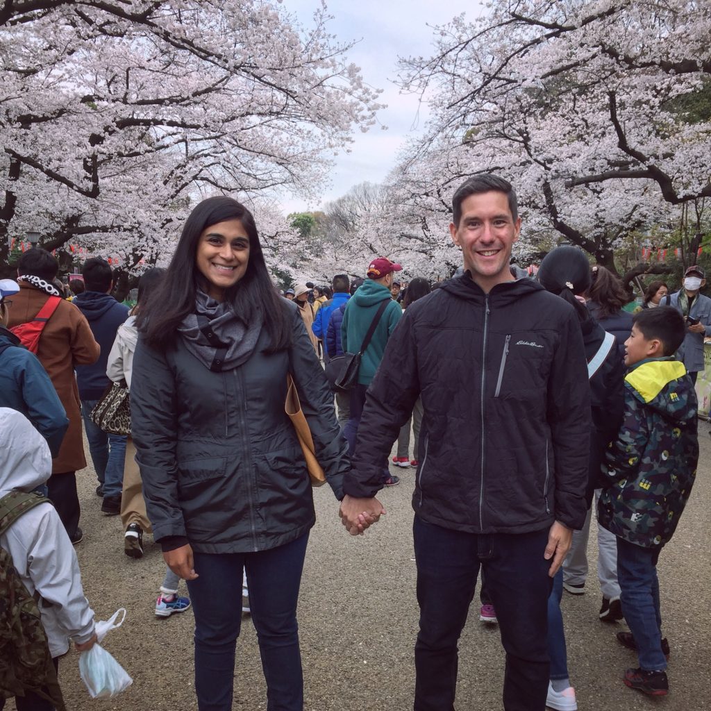 Couple holding hands under Cherry Blossoms in Tokyo