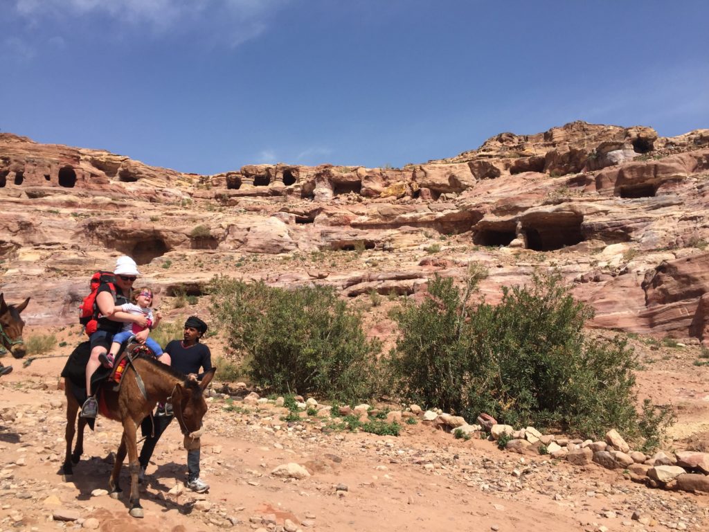 terrified child riding donkey at Petra