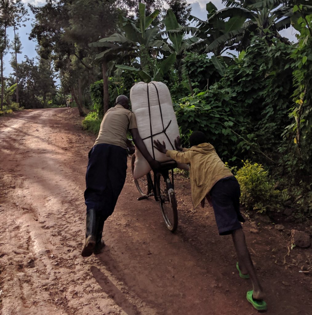 Men pushing bicycle in Rwanda